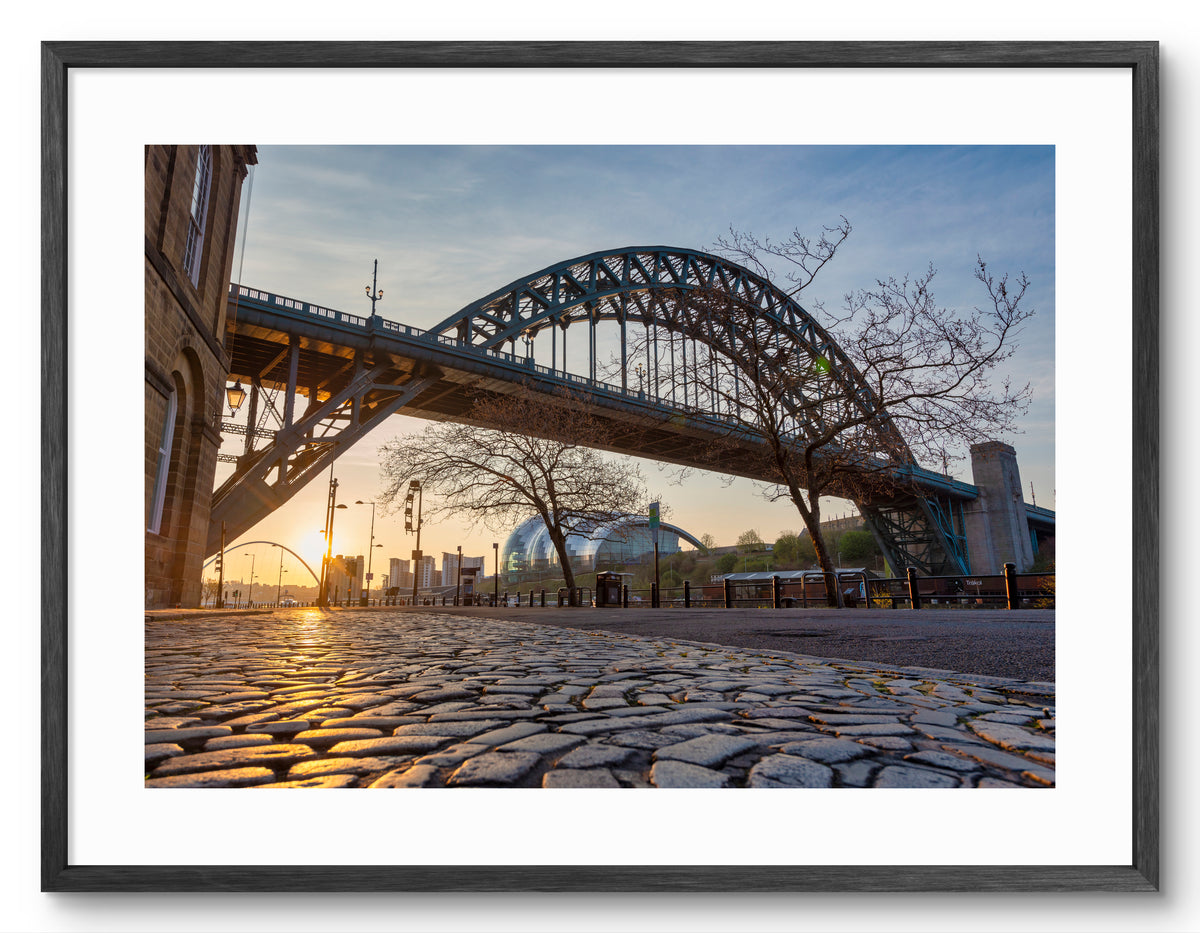 The Quayside - Cobbled Street at Sunrise - Newcastle shown as a framed photographic print.