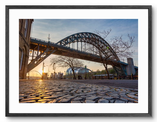 The Quayside - Cobbled Street at Sunrise - Newcastle shown as a framed photographic print.