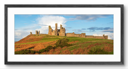 Dunstanburgh Castle Gatehouse panoramic print — black frame and white mount