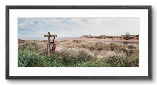 Lifebuoy & Coastal Sand Dunes panoramic print — black frame and white mount