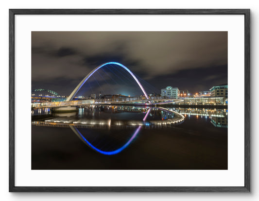Millennium Bridge Gateshead - Reflecting on The River Tyne at Night - Newcastle shown as a framed photographic print.
