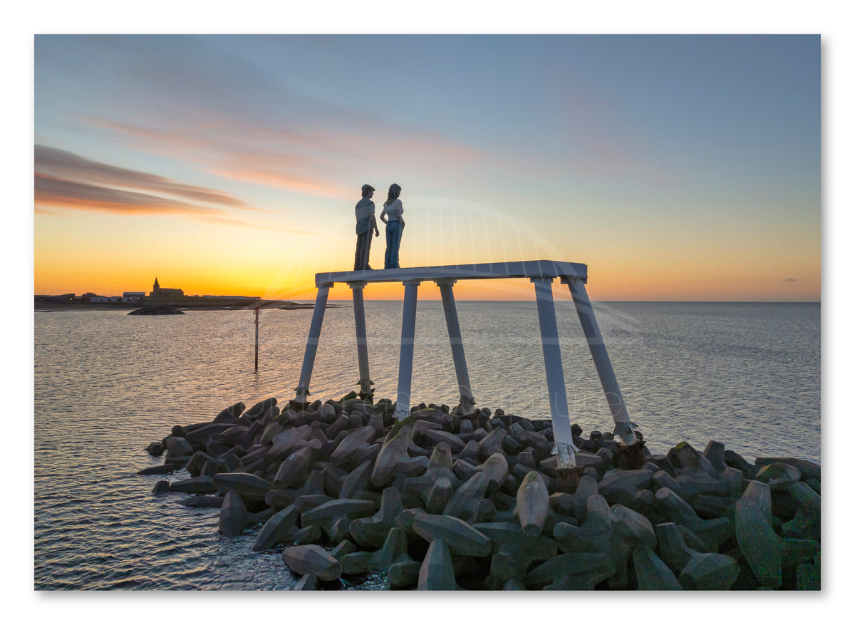 The Couple - looking out to sea Sunrise - Newbiggin By The Sea shown as a canvas print.