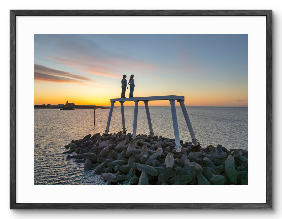 The Couple - looking out to sea Sunrise - Newbiggin By The Sea shown as a framed photographic print.