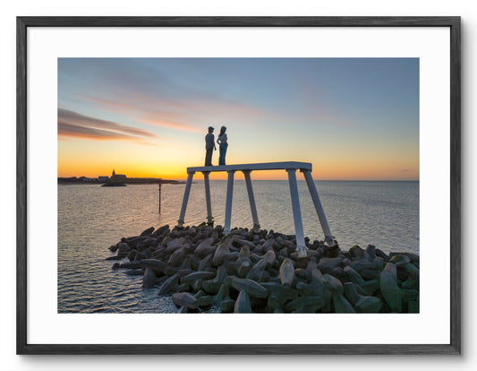 The Couple - looking out to sea Sunrise - Newbiggin By The Sea shown as a framed photographic print.