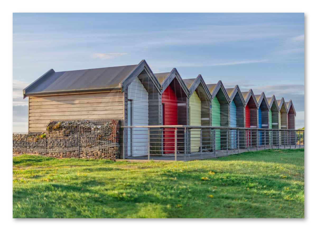 Colourful beach huts at Blyth shown as a canvas print.