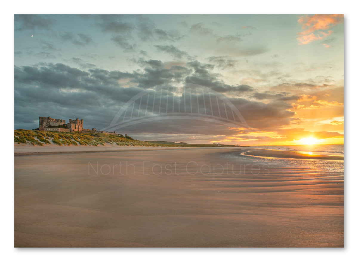 Bamburgh Castle at sunset shown as a canvas print.