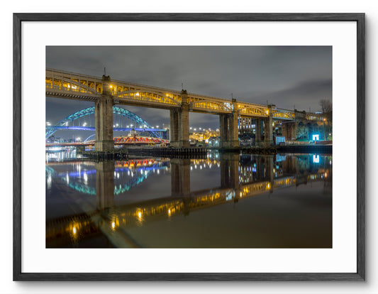 Newcastle Bridges - Crossing The Tyne at Night - Newcastle - Gateshead shown as a framed photographic print.