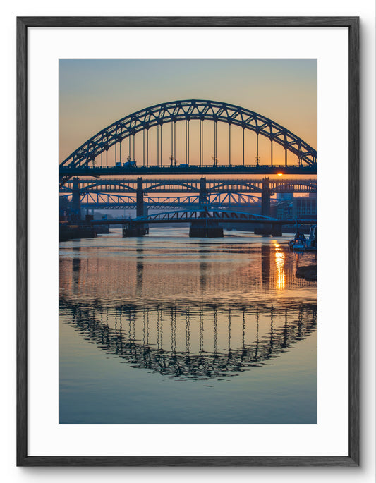 Newcastle Bridges crossing The River Tyne - Sunset River reflections - Gateshead - Newcastle shown as a framed photographic print.
