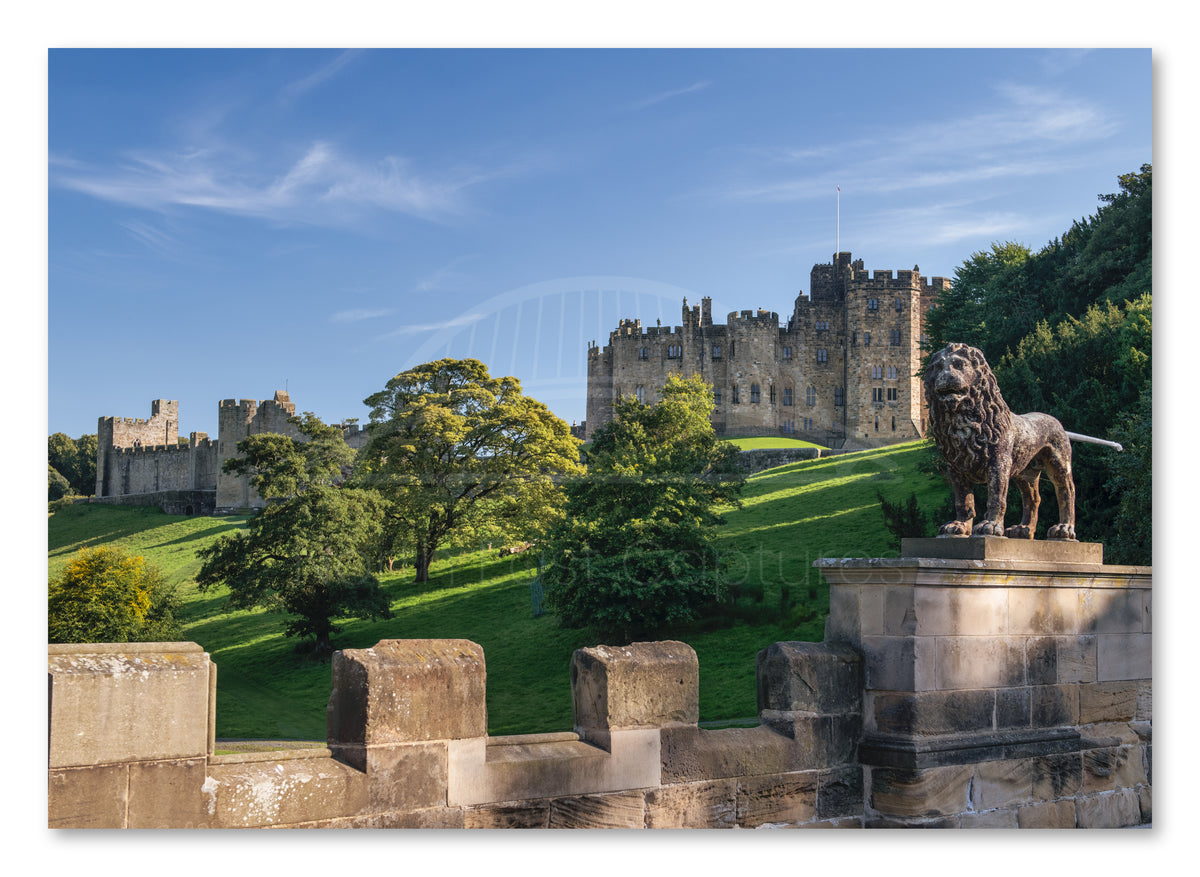 Canvas print of Alnwick Castle viewed from Lion Bridge in Northumberland.
