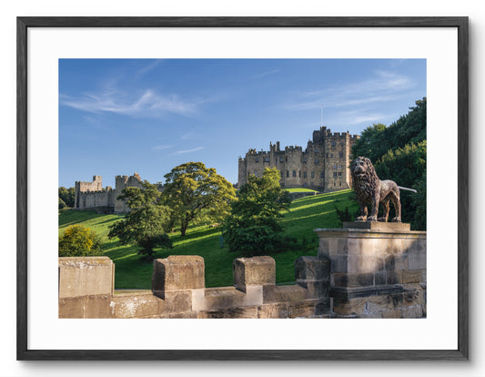 Framed print of Alnwick Castle viewed from Lion Bridge in Northumberland.