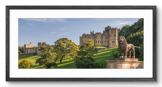 Alnwick Castle from Lion Bridge panoramic print — black frame and white mount