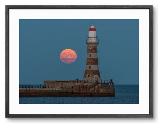 Roker Pier Lighthouse - Harvest Moon - Sunderland shown as a framed photographic print.