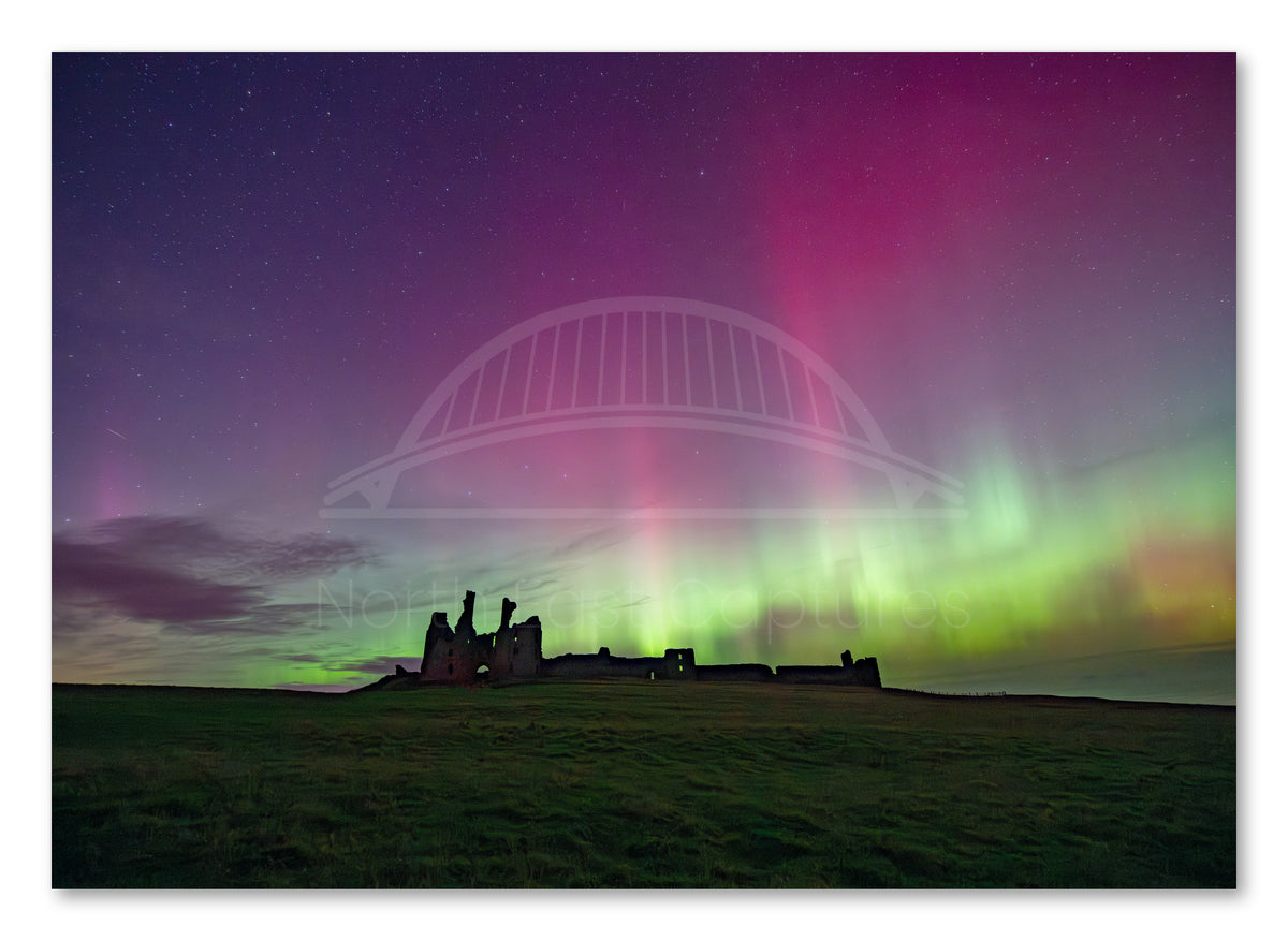 Northern Lights above Dunstanburgh Castle shown as a canvas print.