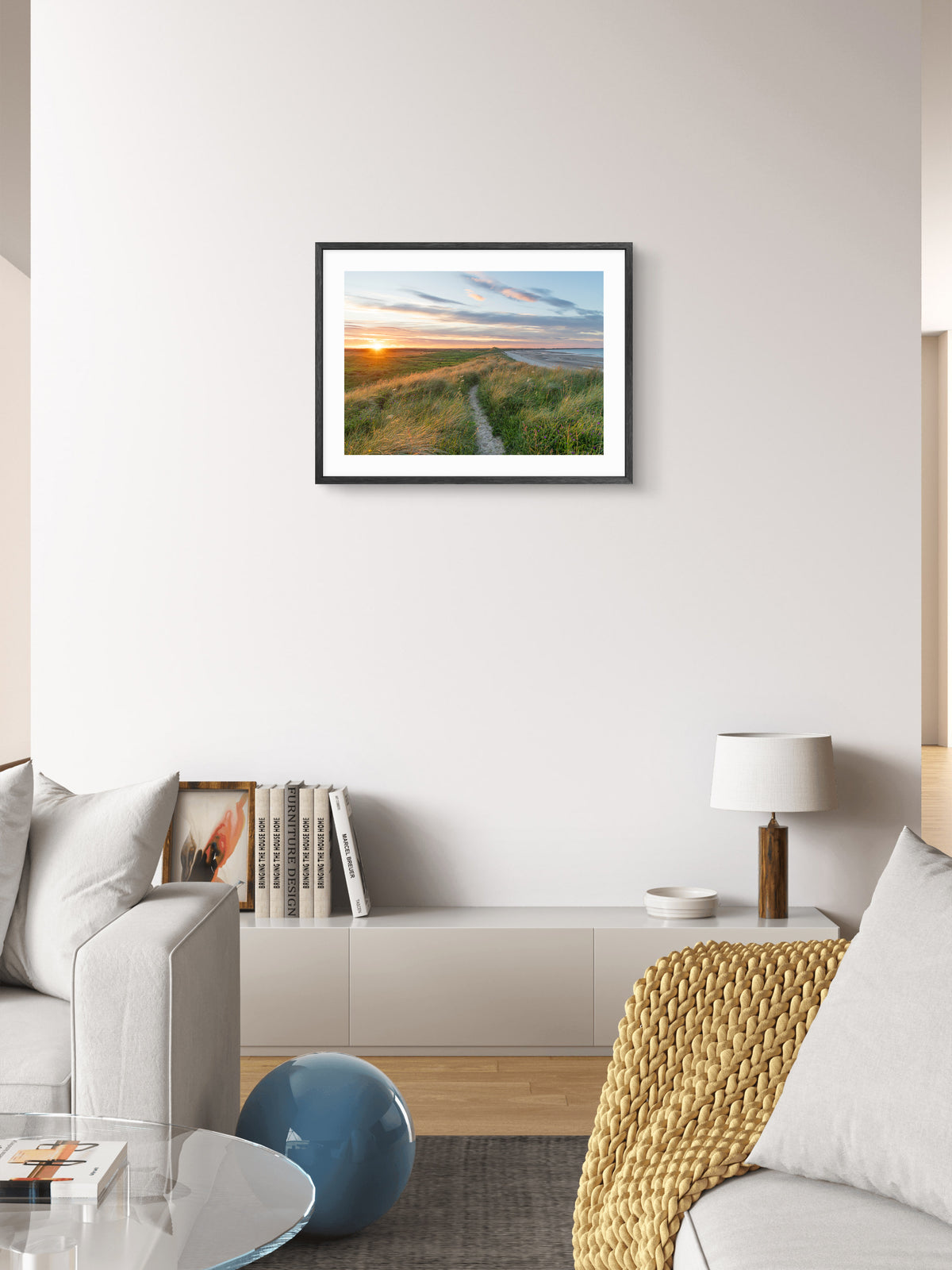 Sunset over grassy dunes at Druridge Bay wall art displayed in a styled room setting.