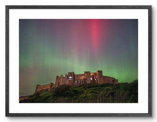 Northern Lights above Bamburgh Castle in Northumberland shown as a framed photographic print.