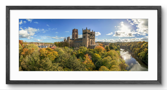Durham Cathedral and the River Wear in autumn, in a black wooden panoramic frame with a white mount.