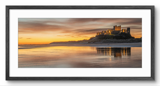 Bamburgh Castle at Sunset panoramic print — black frame and white mount
