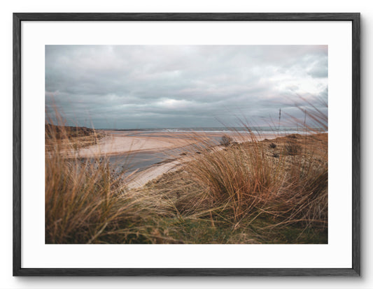 Framed print of the River Aln meeting the North Sea at Alnmouth in Northumberland.