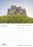 A printed calendar page featuring a scenic photograph of Warkworth Castle on a hill covered in yellow flowers, with the calendar grid for April 2027 below. The page has a white background with thin red border lines and small circular logo marks near the top and bottom.