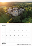 A monthly calendar page for May 2027 featuring a large aerial photograph of Lumley Castle in County Durham surrounded by green trees, with the castle highlighted by warm golden sunlight. The lower section contains the calendar grid, location text, a small map, and the website www.