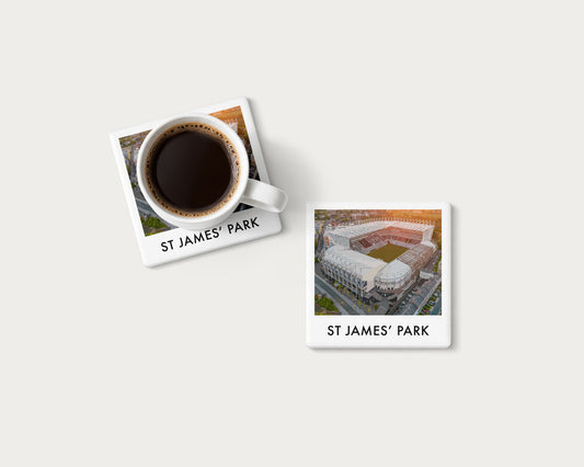 Illustrated ceramic coaster showing an aerial view of St James’ Park in warm sunlight; mockup with a coffee mug.