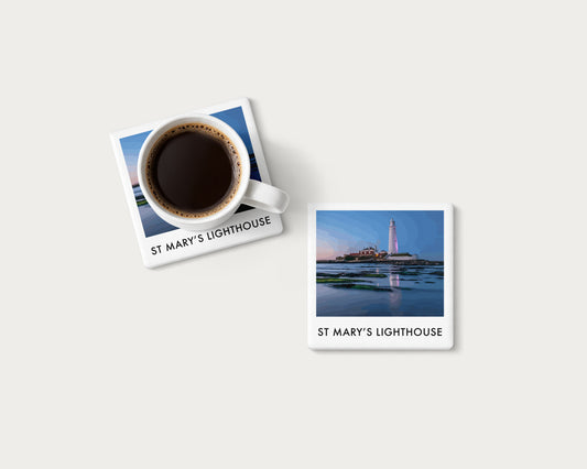 Illustrated ceramic coaster showing St Mary’s Lighthouse reflected in coastal rock pools at blue hour; mockup with a coffee mug.