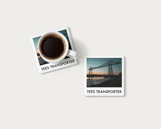 Illustrated ceramic coaster showing the Tees Transporter Bridge silhouetted against a dusk sky; mockup with a coffee mug.