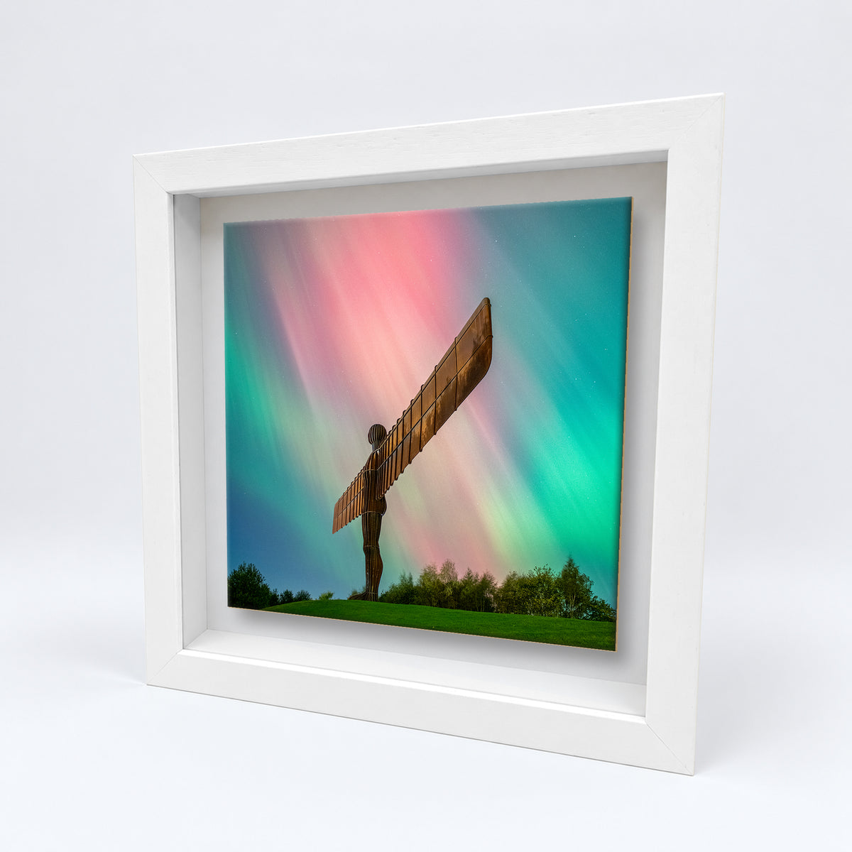 Angel of the North Northern Lights on an 8×8 inch ceramic tile in a white box frame, angled view