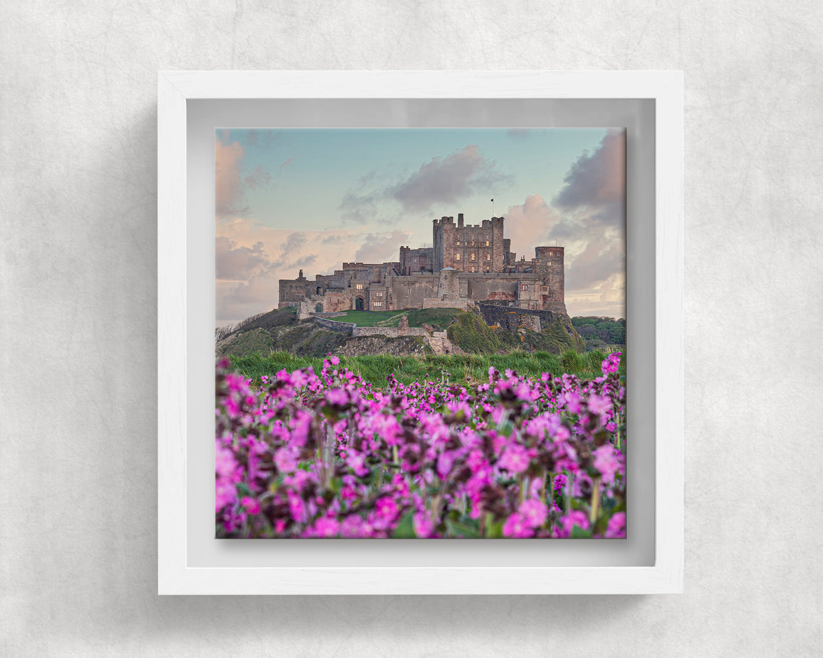 Bamburgh Castle and Flowers on an 8×8 inch ceramic tile in a white box frame, front view