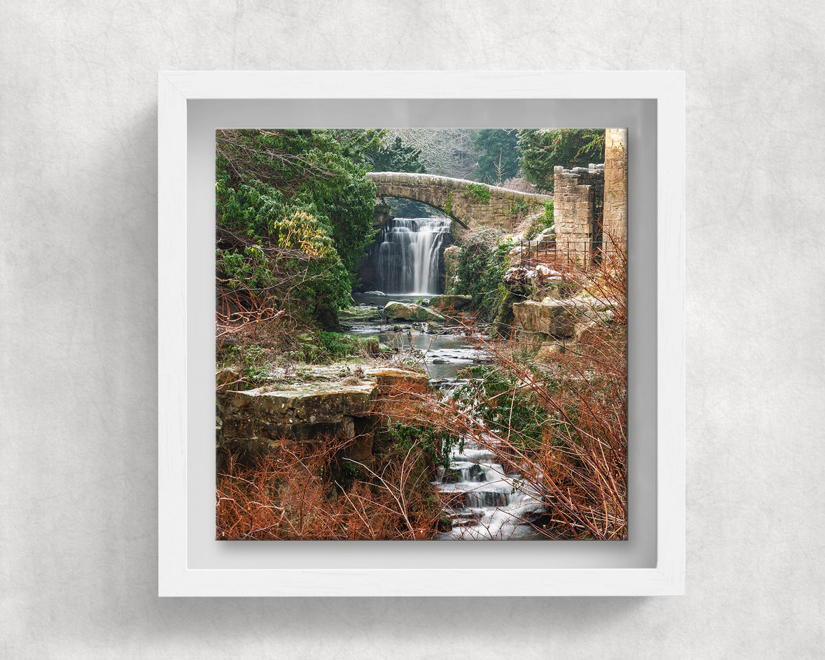 Jesmond Dene Waterfall on an 8×8 inch ceramic tile in a white box frame, front view