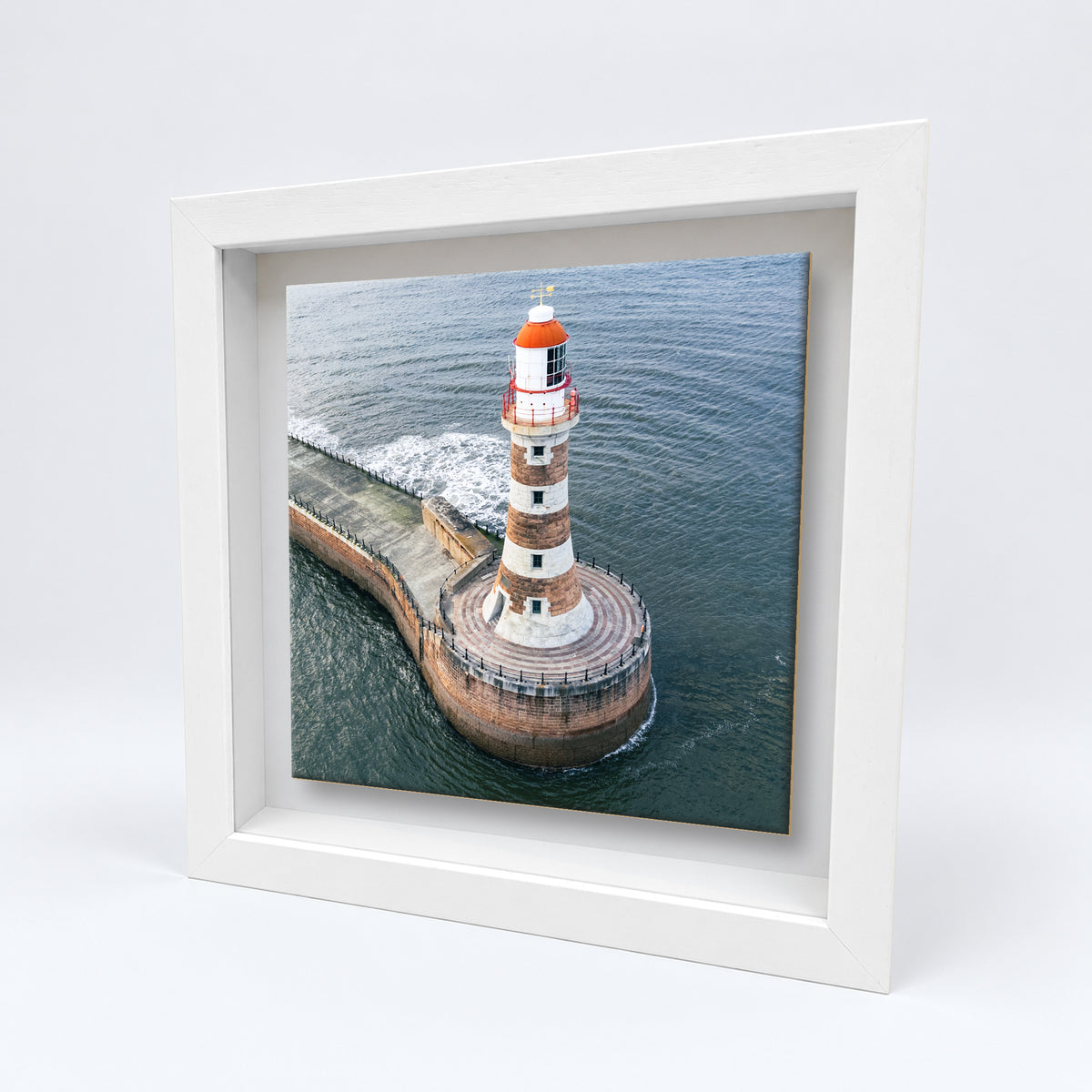 Roker Lighthouse Aerial View on an 8×8 inch ceramic tile in a white box frame, angled view