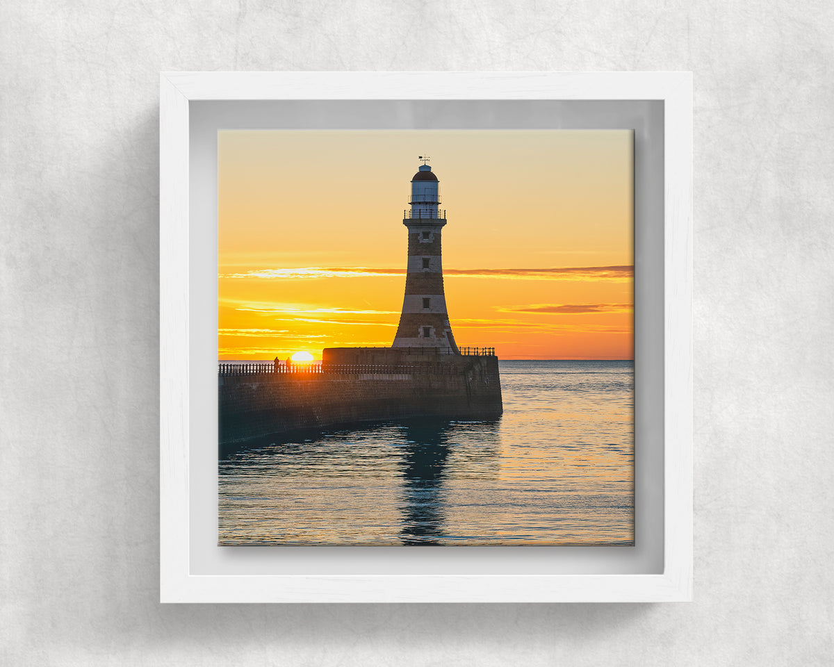Roker Lighthouse Sunrise on an 8×8 inch ceramic tile in a white box frame, front view