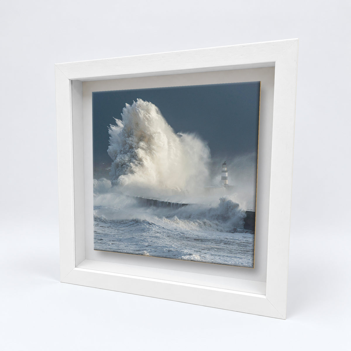 Seaham Lighthouse Breaking Wave on an 8×8 inch ceramic tile in a white box frame, angled view