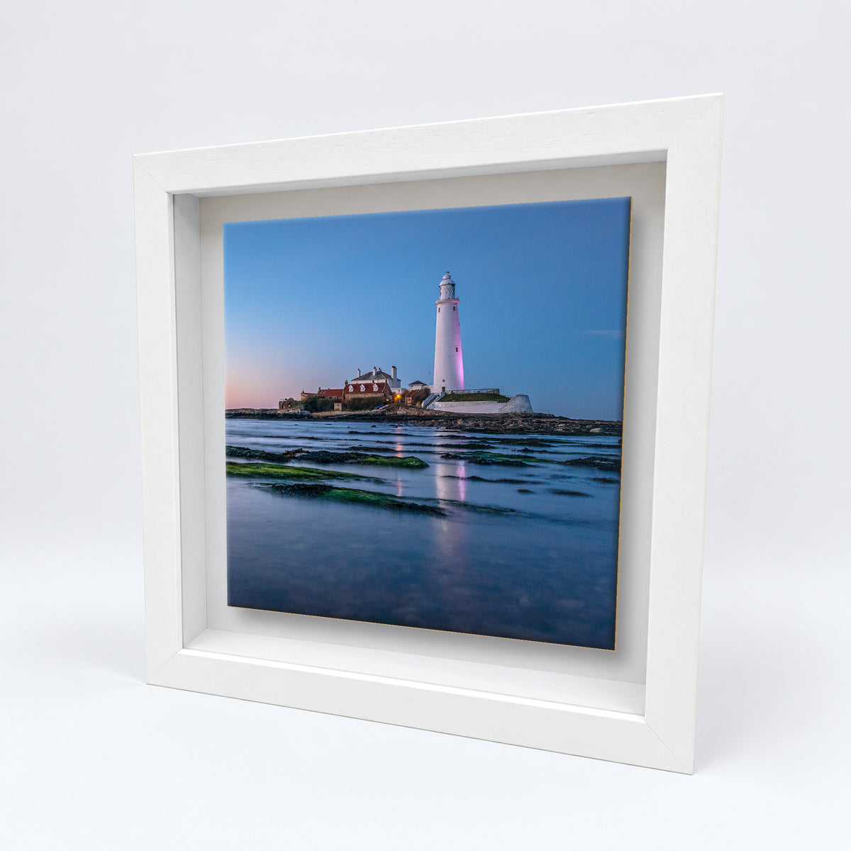 St Mary's Lighthouse ceramic tile in a white solid wood box frame, angled view