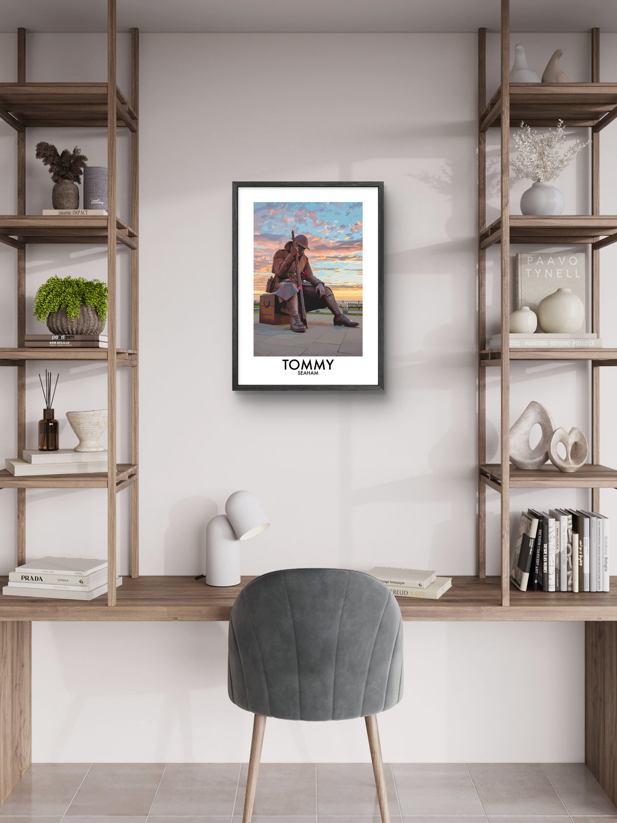 Framed Tommy Seaham vector art print displayed above a desk between wooden shelves