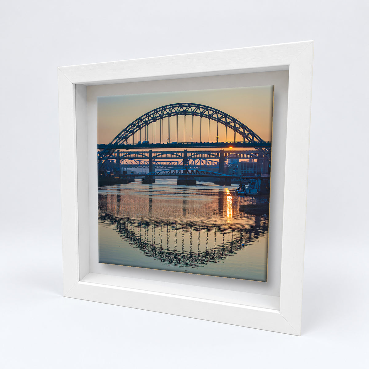 Tyne Bridges Reflections on an 8×8 inch ceramic tile in a white box frame, angled view