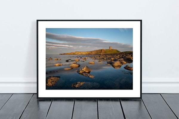 Boulder Beach,Death Rocks in Embelton looking towards the ruins of Dunstanburgh Castle, perched on the dolerite rocks of the Great Whin Sill - North East Captures